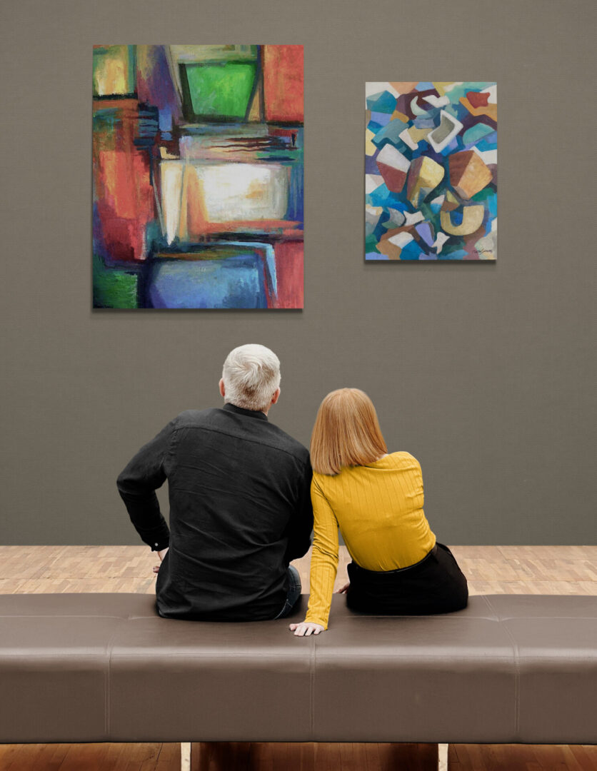Two people sitting on a bench admiring local fine art for sale in an art gallery.