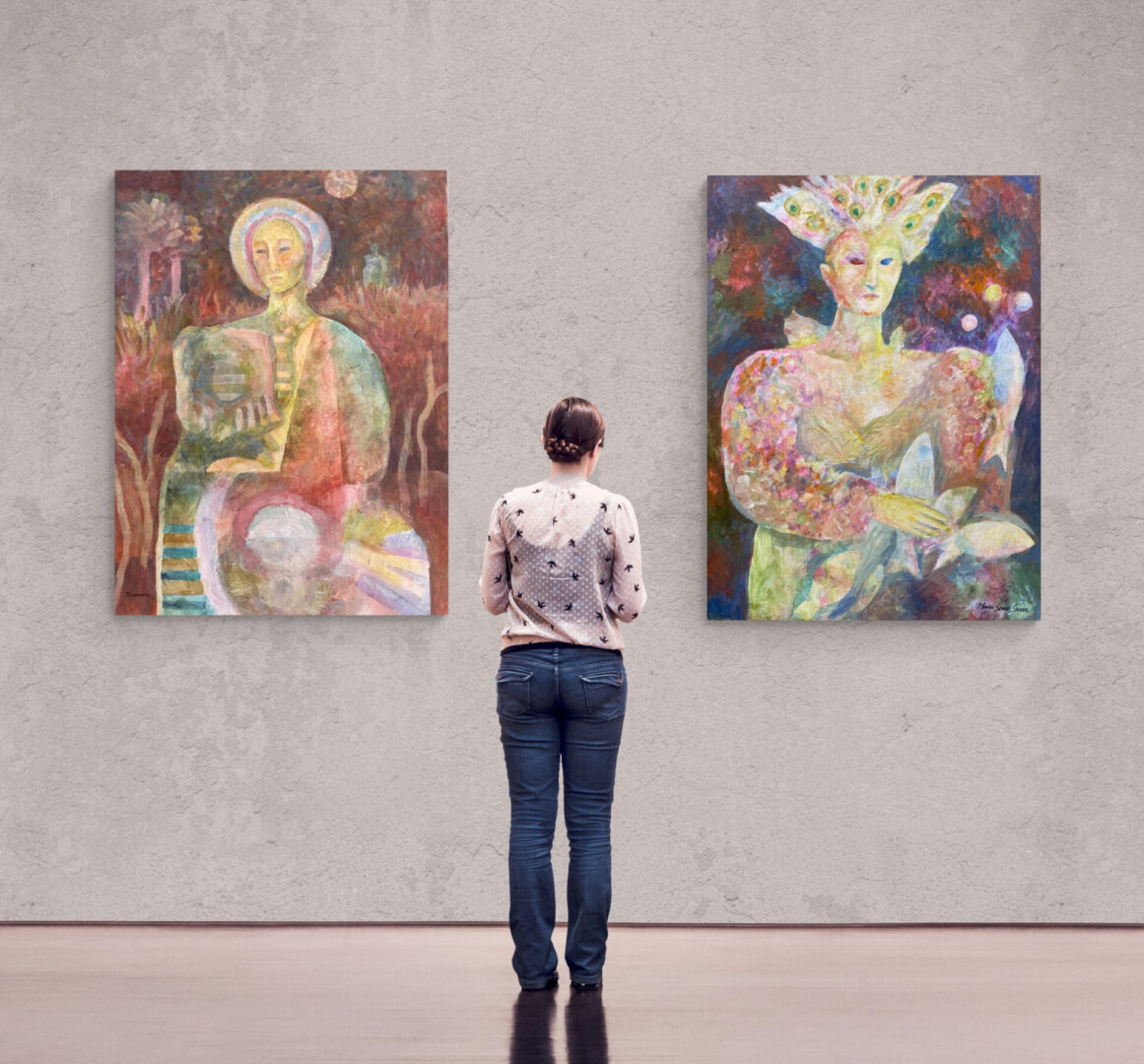 A woman admiring two local fine art paintings for sale in an art gallery.