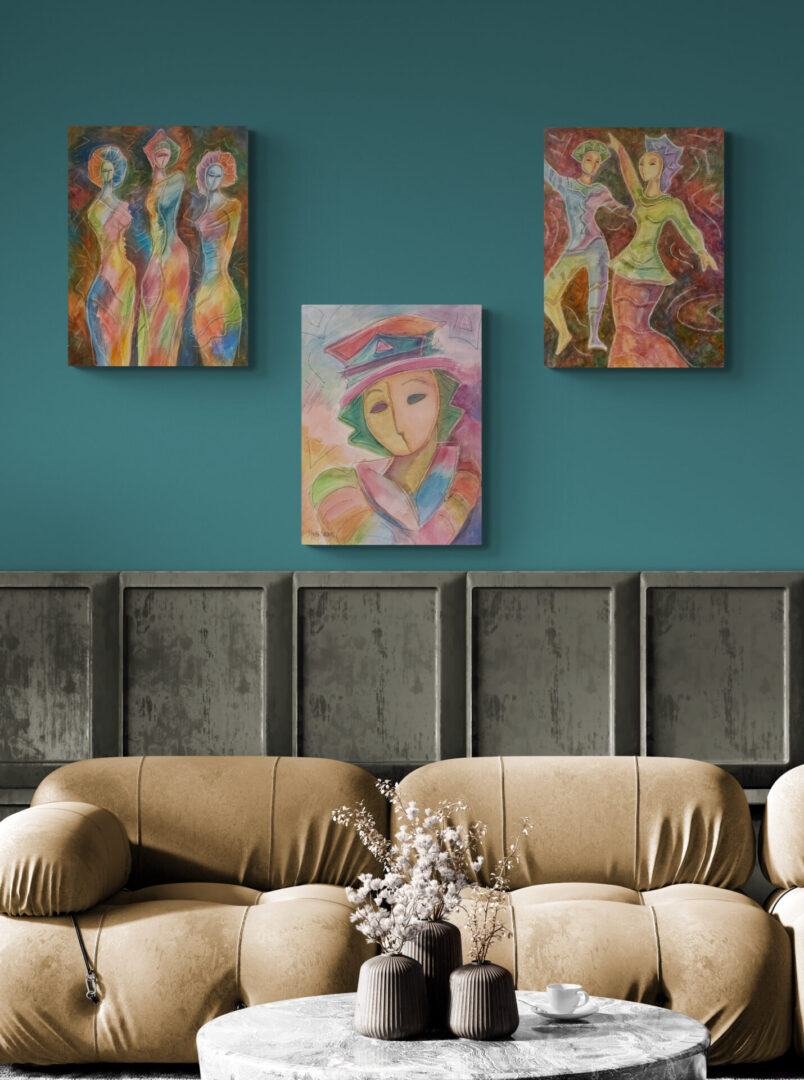 Three local fine art paintings hanging above a couch in a living room.