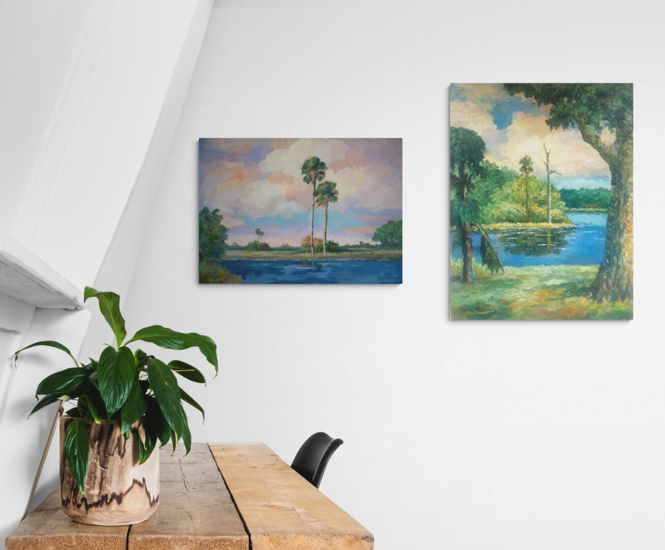 Two local fine art paintings hanging on the wall of a room, available for sale.