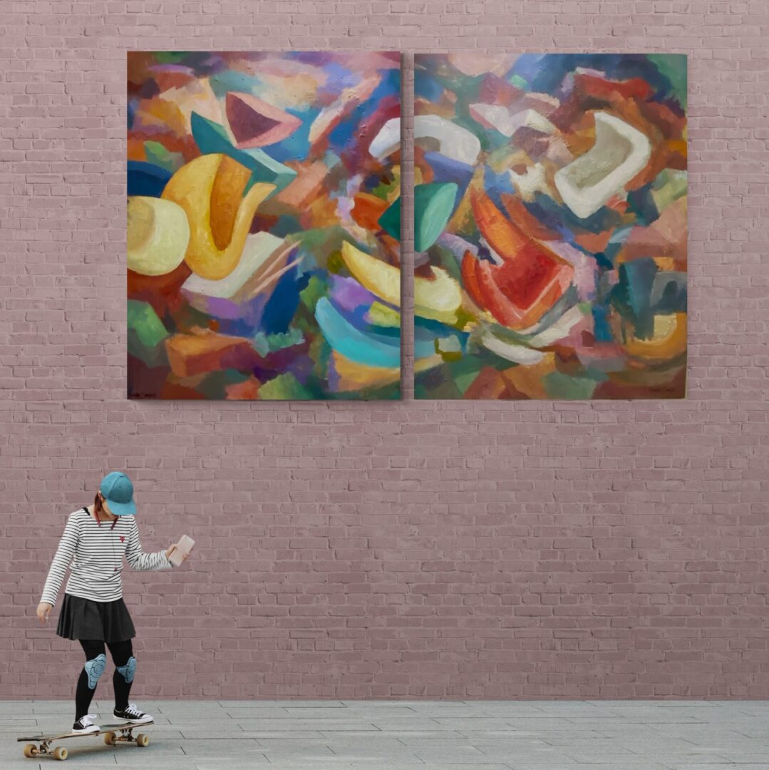 A skateboarder performing tricks in front of two local fine art paintings available for sale.
